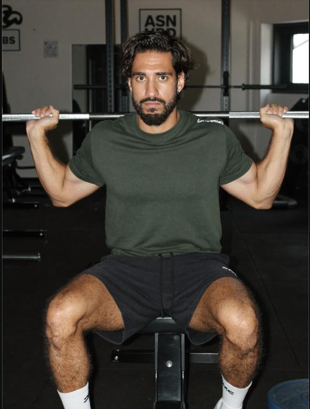 Man performing a front squat, a compound lift used in strength programs