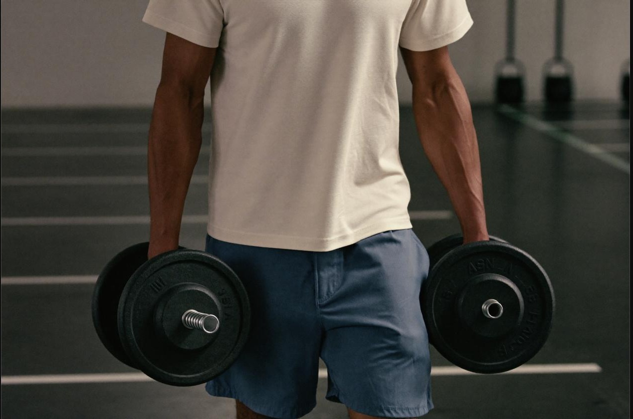 Man performing a heavy farmer’s carry with dumbbells, a classic grip-strength exercise