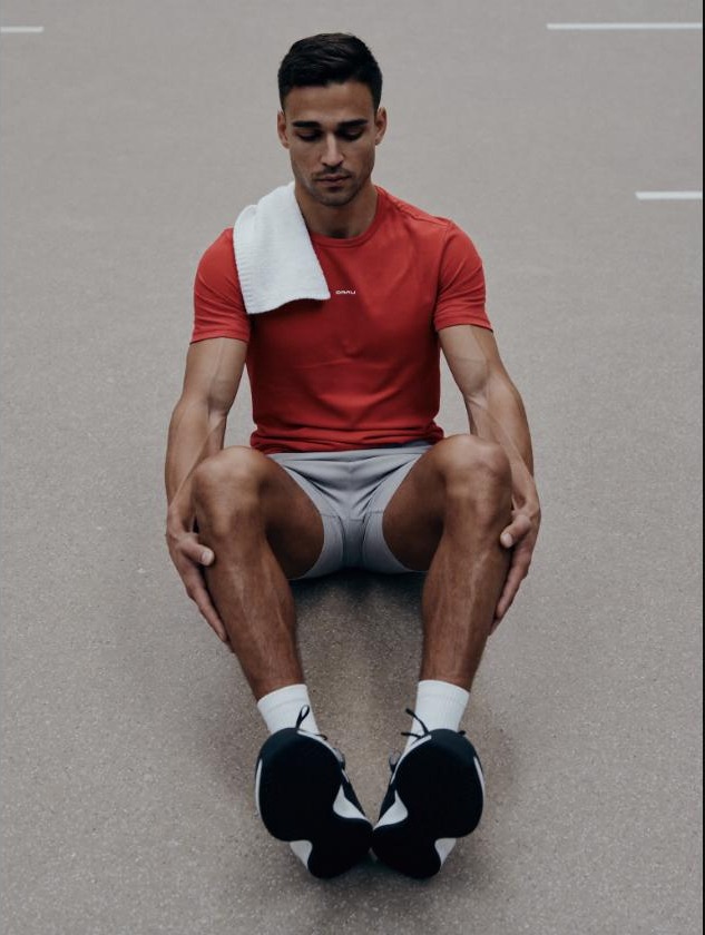 Man foam rolling his quads after a training session