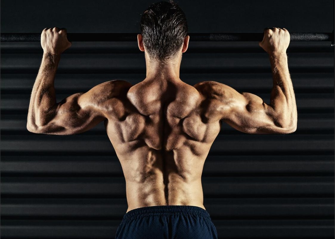 Athlete performing a wide-grip pull-up